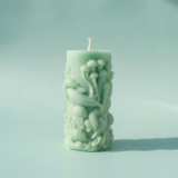 Handcrafted seafoam green pillar candle from The Angelina Store's Oceanica Spa Collection. Elegant sculptural candle featuring intricate raised designs of jellyfish, coral, and underwater sea life. Calming spa-inspired candle in a soft mint green color, perfect for creating a serene, ocean-inspired atmosphere. Artisan home decor and meditation candle made with premium wax blend.