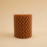 Caramel-colored Bubble Pillar candle featuring a playful raised bubble texture, Nag Champa scented.