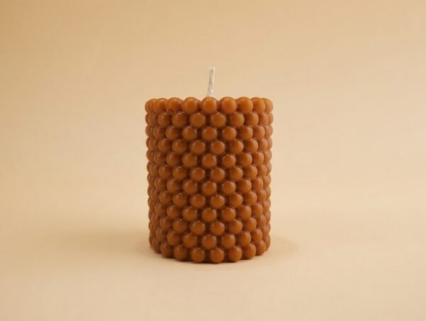 Caramel-colored Bubble Pillar candle featuring a playful raised bubble texture, Nag Champa scented.