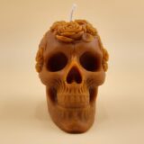 Close-up of the Skull Pillar candle from The Angelina Store – a handcrafted caramel pillar candle featuring a detailed sugar skull design with floral crown, infused with rich Nag Champa fragrance.