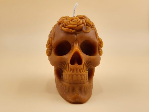 Close-up of the Skull Pillar candle from The Angelina Store – a handcrafted caramel pillar candle featuring a detailed sugar skull design with floral crown, infused with rich Nag Champa fragrance.